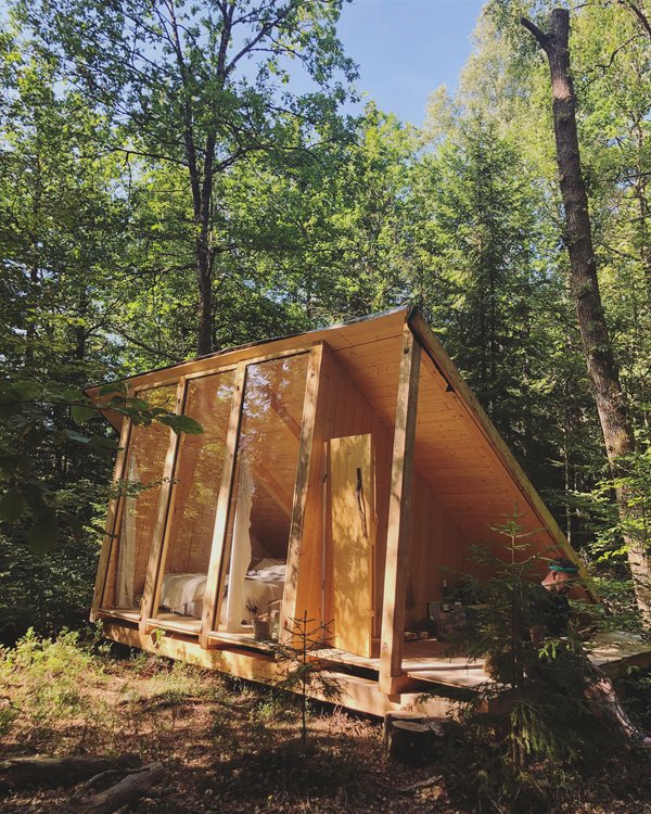 An a-frame cabin with big windows