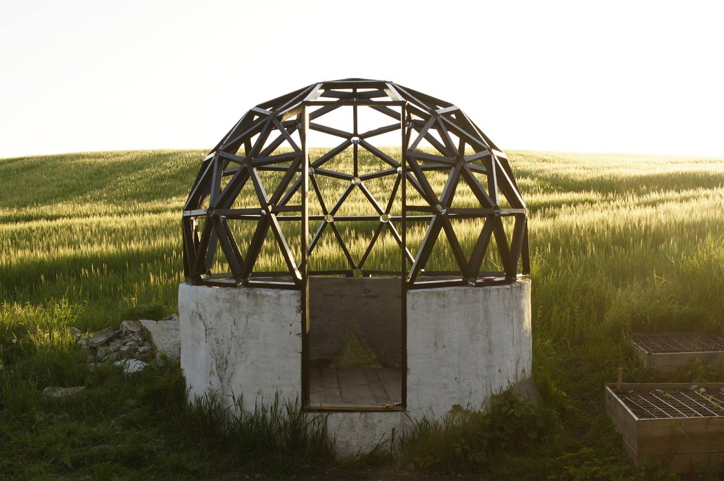 Green house dome structure in front of field