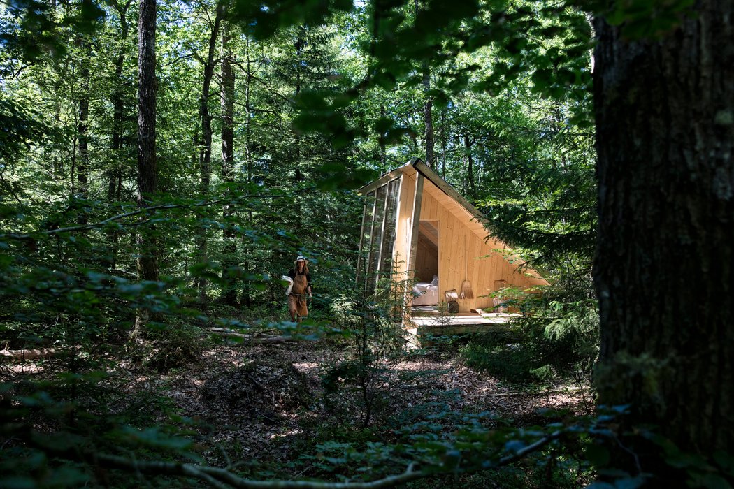 A triangualar cabin with a woman
